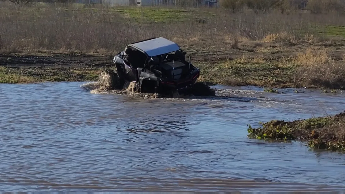 RZR UTV splashing through the water crossing at 281 Country Club, San Antonio