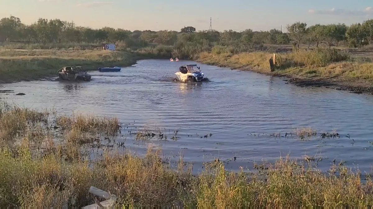 Two UTVs crossing 281CC pond at golden hour sunset