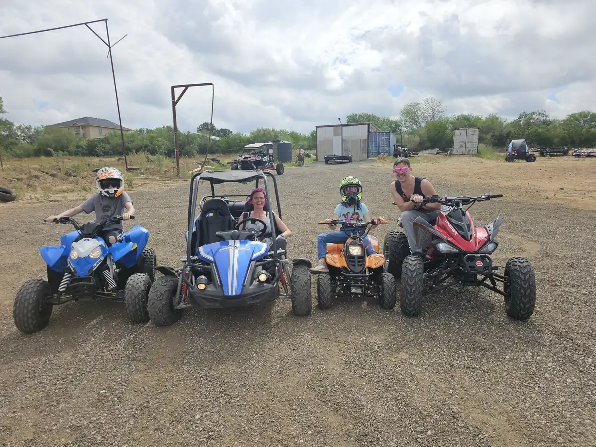Family riding ATVs together at 281 Country Club, San Antonio